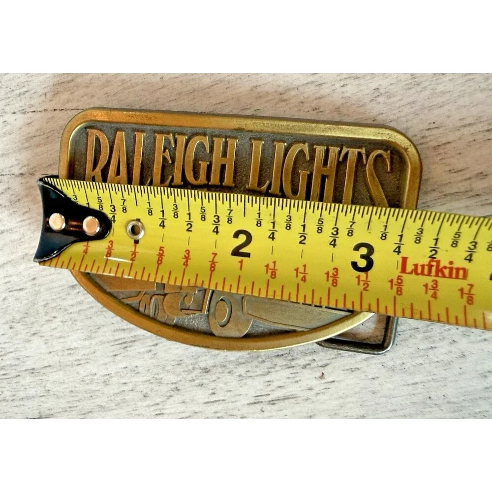 Vintage Raleigh Lights Belt Buckle 1970s Brass Tone Semi Truck Advertising USA